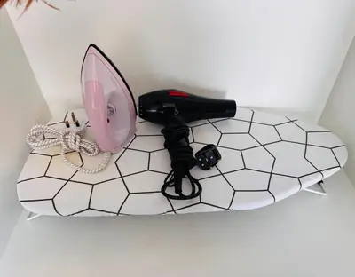 a table with a mirror and a phone on a tile floor at Robertson Residence by Aspire Suites in Kuala Lumpur