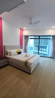 a bedroom with a large bed and a large window at Crystal Exclusive Suites KLCC in Kuala Lumpur