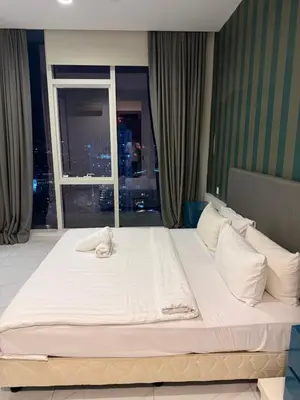 a large white bed in a room with a window at Platinum kuala lumpur by Bright Suites in Kuala Lumpur
