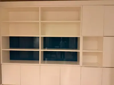 a white book shelf with two windows at Platinum kuala lumpur by Bright Suites in Kuala Lumpur