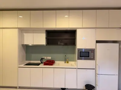 a white kitchen with a sink and a microwave at Platinum kuala lumpur by Bright Suites in Kuala Lumpur