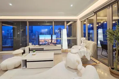 a living room with white furniture and large windows at Panoramic KL View Bintang Fairlane Residence 3BR #21 in Kuala Lumpur