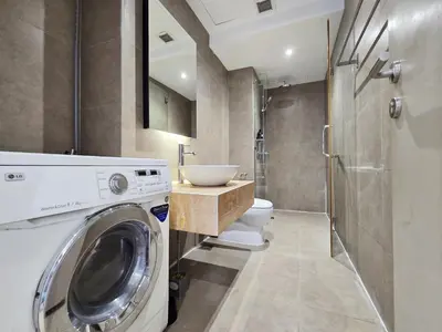 a bathroom with a washing machine and a sink at Panoramic KL View Bintang Fairlane Residence 3BR #21 in Kuala Lumpur