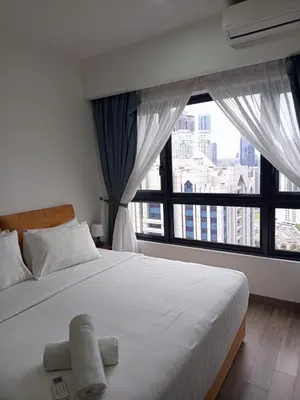 a bedroom with a large bed with a large window at KL Residence By Agile Suites in Kuala Lumpur