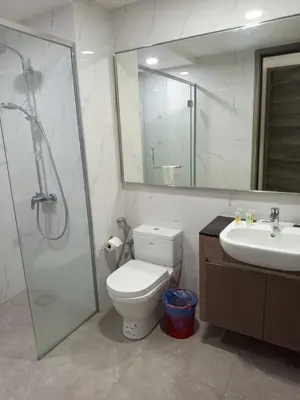 a bathroom with a toilet and a shower and a sink at KL Residence By Agile Suites in Kuala Lumpur