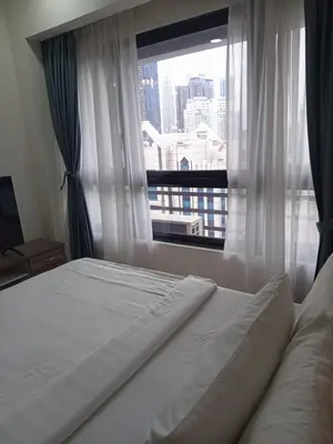 a bedroom with a bed and a large window at KL Residence By Agile Suites in Kuala Lumpur