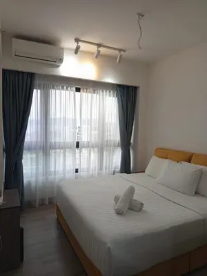 a bedroom with a bed with a stuffed animal on it at KL Residence By Agile Suites in Kuala Lumpur