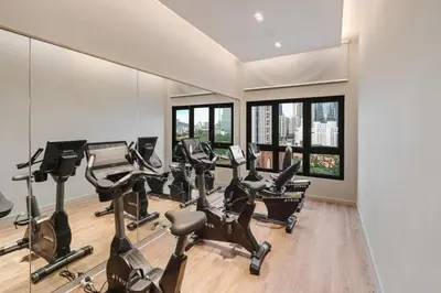 a gym with treadmills and elliptical machines at Deluxe 2BR Agile Bukit Bintang by RumaBnB in Kuala Lumpur