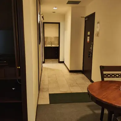a hallway with a table and a room at Home World Apartment At Times Square in Kuala Lumpur