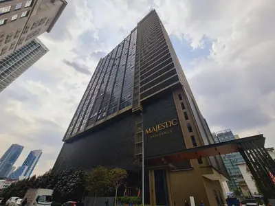 a tall building with a sign in front of it at Home For Traveler At Majestic Residence in Kuala Lumpur
