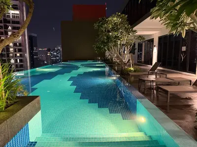 a pool on the roof of a building at night at KLCC Majestic Residence By Vglory Home in Kuala Lumpur