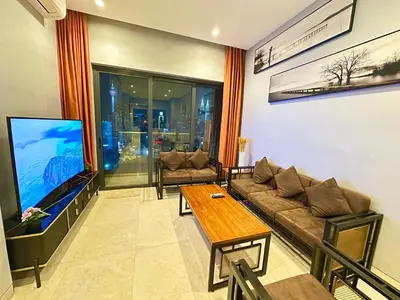 a living room with a couch and a tv at Lucentia Universal Stay Kuala Lumpur in Kuala Lumpur