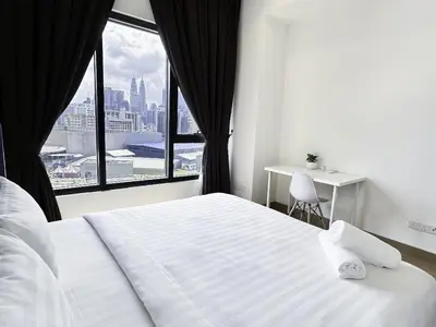 a bedroom with a large white bed and a window at Lucentia Universal Stay Kuala Lumpur in Kuala Lumpur