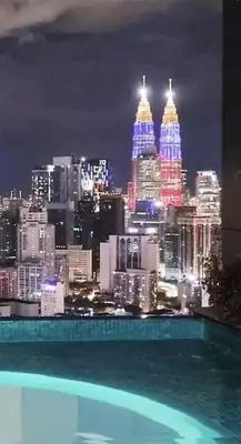 a view of a city skyline at night at Lucentia Universal Stay Kuala Lumpur in Kuala Lumpur