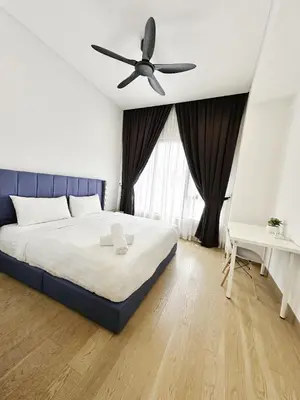 a bedroom with a bed with a ceiling fan at Lucentia Universal Stay Kuala Lumpur in Kuala Lumpur