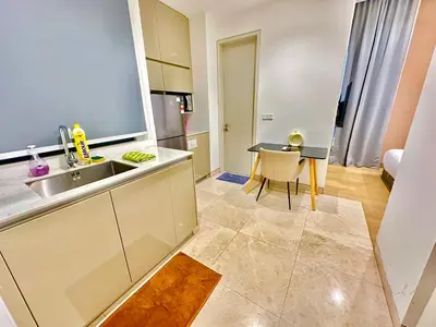 a kitchen with a sink and a table at Lucentia Universal Stay Kuala Lumpur in Kuala Lumpur