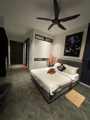 a bedroom with a bed with a ceiling fan at KLCC View Suites By Scarletz in Kuala Lumpur