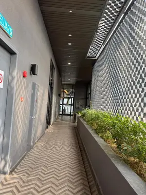 a hallway of a building with plants on the side at KLCC View Suites By Scarletz in Kuala Lumpur