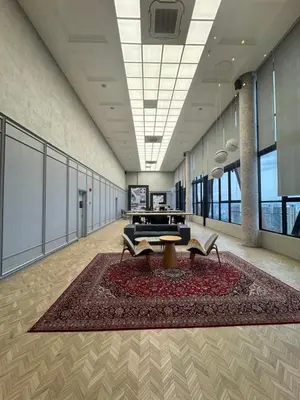 a large room with a table and a rug at KLCC View Suites By Scarletz in Kuala Lumpur