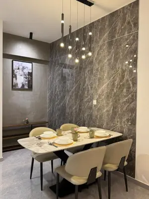 a dining room with a table and chairs at KLCC View Suites By Agile in Kuala Lumpur