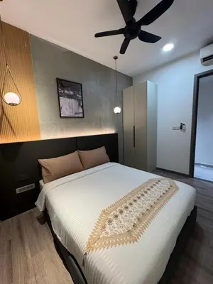 a bedroom with a large bed with a ceiling fan at KLCC View Suites By Agile in Kuala Lumpur