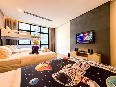 a bedroom with two beds with a toy gun on the floor at KLCC Spacious Top Floor, Grand, Slides and Big Bathtub Kula Lumpur in Kuala Lumpur