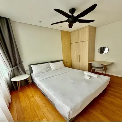 a bedroom with a white bed with a ceiling fan at sky suites klcc by dp in Kuala Lumpur