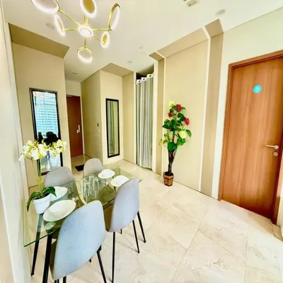 a dining room with a glass table and chairs at sky suites klcc by dp in Kuala Lumpur