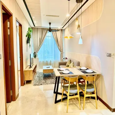 a dining room with a table and chairs and a couch at sky suites klcc by dp in Kuala Lumpur