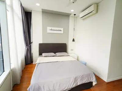 a bedroom with a bed and a window at Tomato Homestay By Sky Suites KLCC in Kuala Lumpur