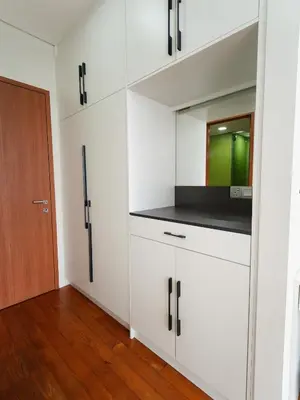 a kitchen with white cabinets and a door at Tomato Homestay By Sky Suites KLCC in Kuala Lumpur