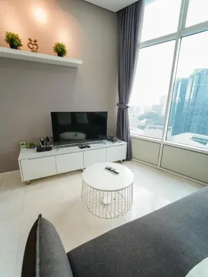 a living room with a table and a large window at Tomato Homestay By Sky Suites KLCC in Kuala Lumpur