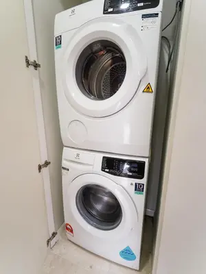 a washer and dryer in a small room at Tomato Homestay By Sky Suites KLCC in Kuala Lumpur