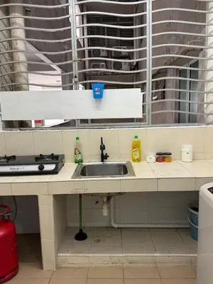 a kitchen counter with a sink in front of a window at Happy Homes 1 Kuala Lumpur in Kuala Lumpur