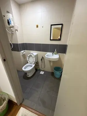 a bathroom with a toilet and a sink at Happy Homes Kuala Lumpur 21-12 in Kuala Lumpur