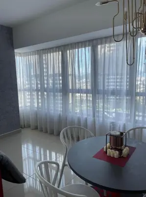 a dining room with a table and chairs and a window at Arte Plus Homestay Condo in Kuala Lumpur