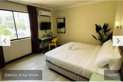 a bedroom with a bed and a desk in it at Hotel Bintang Inn in Kuala Lumpur