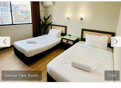 two beds in a hotel room with two beds sidx sidx sidx at Hotel Bintang Inn in Kuala Lumpur