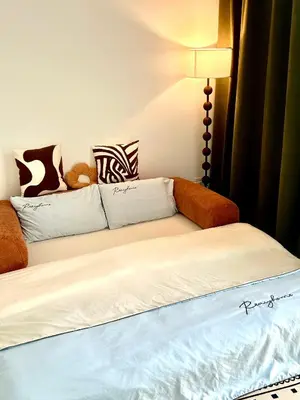a bed with a couch with a teddy bear on it at Only Girls Condo at KL city, near monorail in Kuala Lumpur