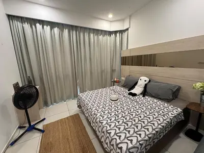 a bedroom with a bed with a stuffed dog on it at The Robertson N9 Jalan Alor Bukit Bintang Petaling Street 7 Pax in Kuala Lumpur