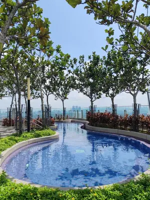 a large swimming pool with trees in the background at The Robertson N9 Jalan Alor Bukit Bintang Petaling Street 7 Pax in Kuala Lumpur
