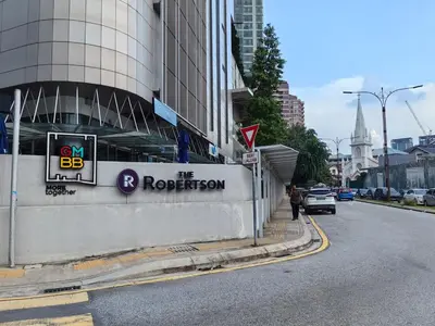 a building with a sign on the side of a street at The Robertson N9 Jalan Alor Bukit Bintang Petaling Street 7 Pax in Kuala Lumpur