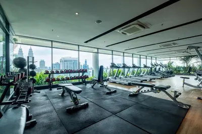 a gym with a lot of exercise equipment in a building at The Colony By Feel Home in Kuala Lumpur