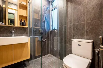 a bathroom with a shower and a toilet and a sink at The Colony By Feel Home in Kuala Lumpur