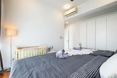 a bedroom with a large bed with a teddy bear on it at 4 mins to KLCC Luxurious Premium Suite in Three28 in Kuala Lumpur