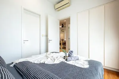 a bedroom with a bed with a teddy bear on it at 4 mins to KLCC Luxurious Premium Suite in Three28 in Kuala Lumpur