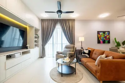 a living room with a couch and a tv at 4 mins to KLCC Luxurious Premium Suite in Three28 in Kuala Lumpur