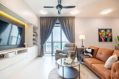 a living room with a couch and a tv at 4 mins to KLCC Luxurious Premium Suite in Three28 in Kuala Lumpur