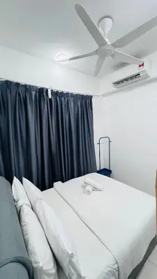 a bed in a room with a ceiling fan at Trion KL Family Residences in Kuala Lumpur