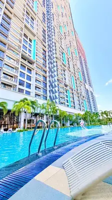 a swimming pool in front of some tall buildings at Trion KL Family Residences in Kuala Lumpur